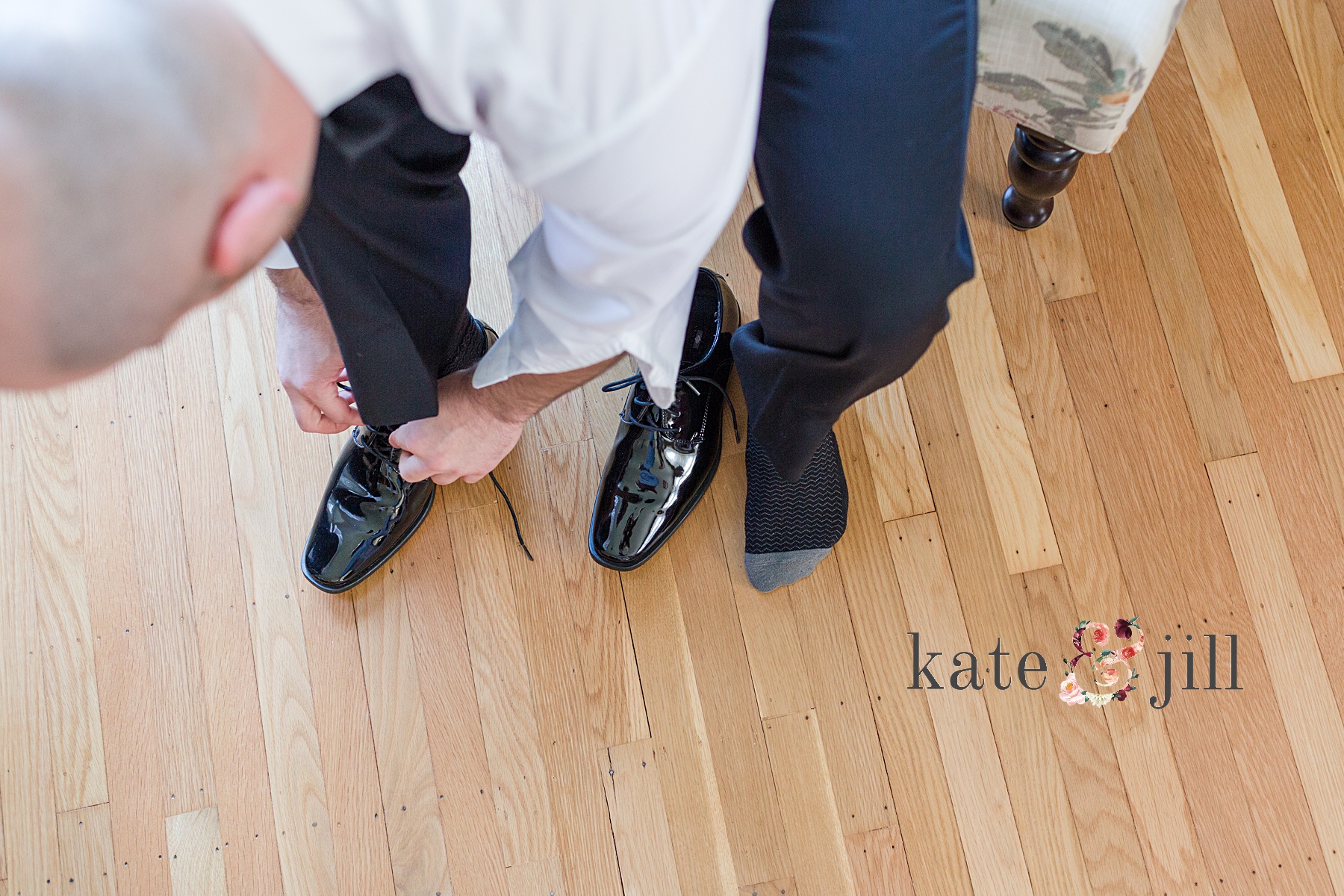 groom tying shoes woodcrest country club wedding