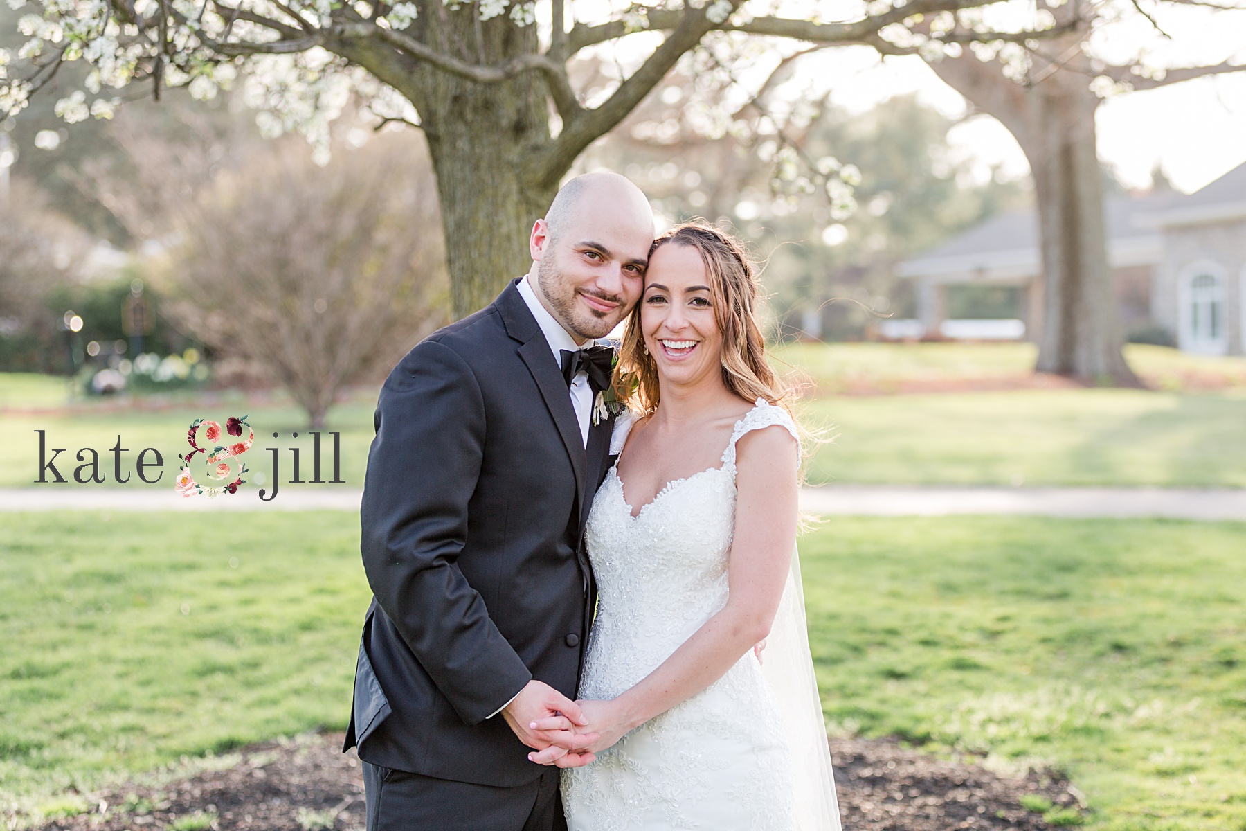 bride and groom smiling in front of tree woodcrest country club wedding