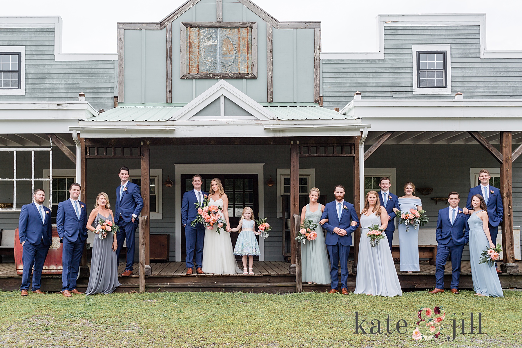 wedding party standing on porch everly at railroad wedding