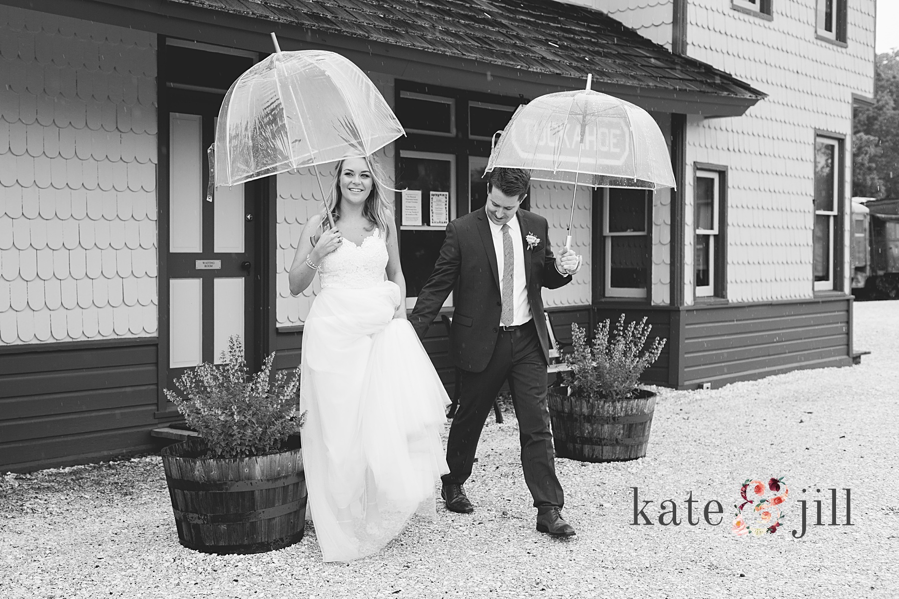 bride and groom running to reception in rain