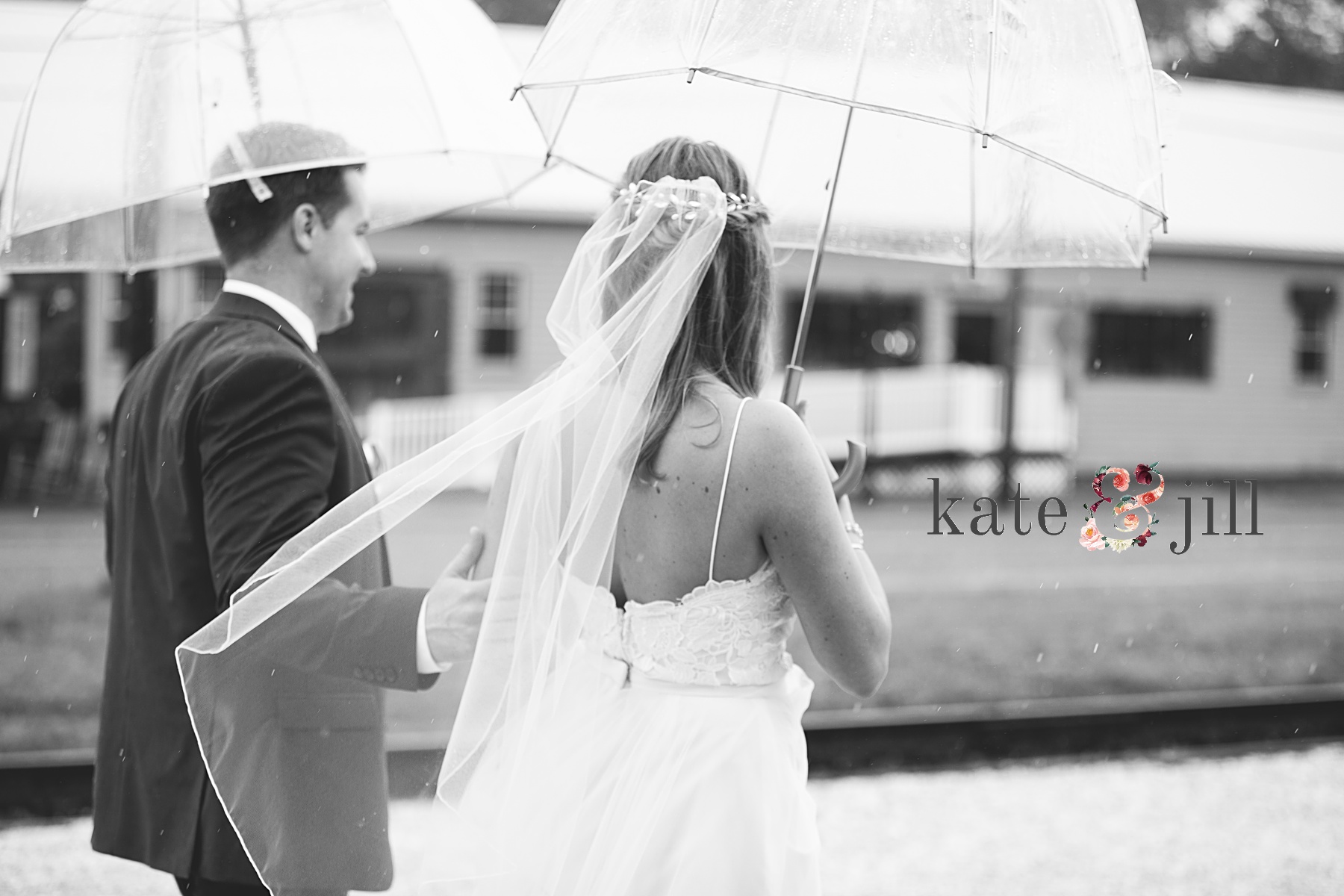 bride and groom rainy day wedding under umbrellas