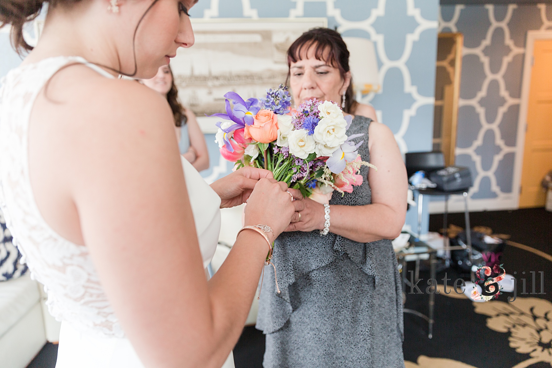 bride putting charms on bouquet