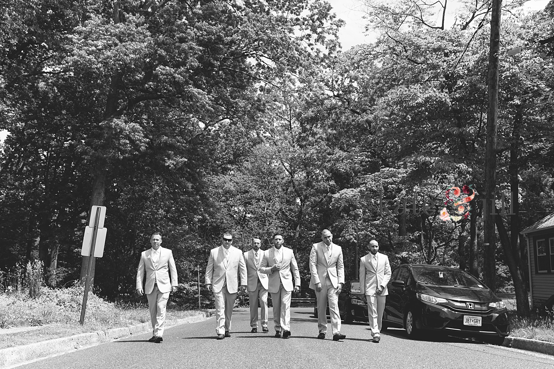 groom and groomsmen walking in street