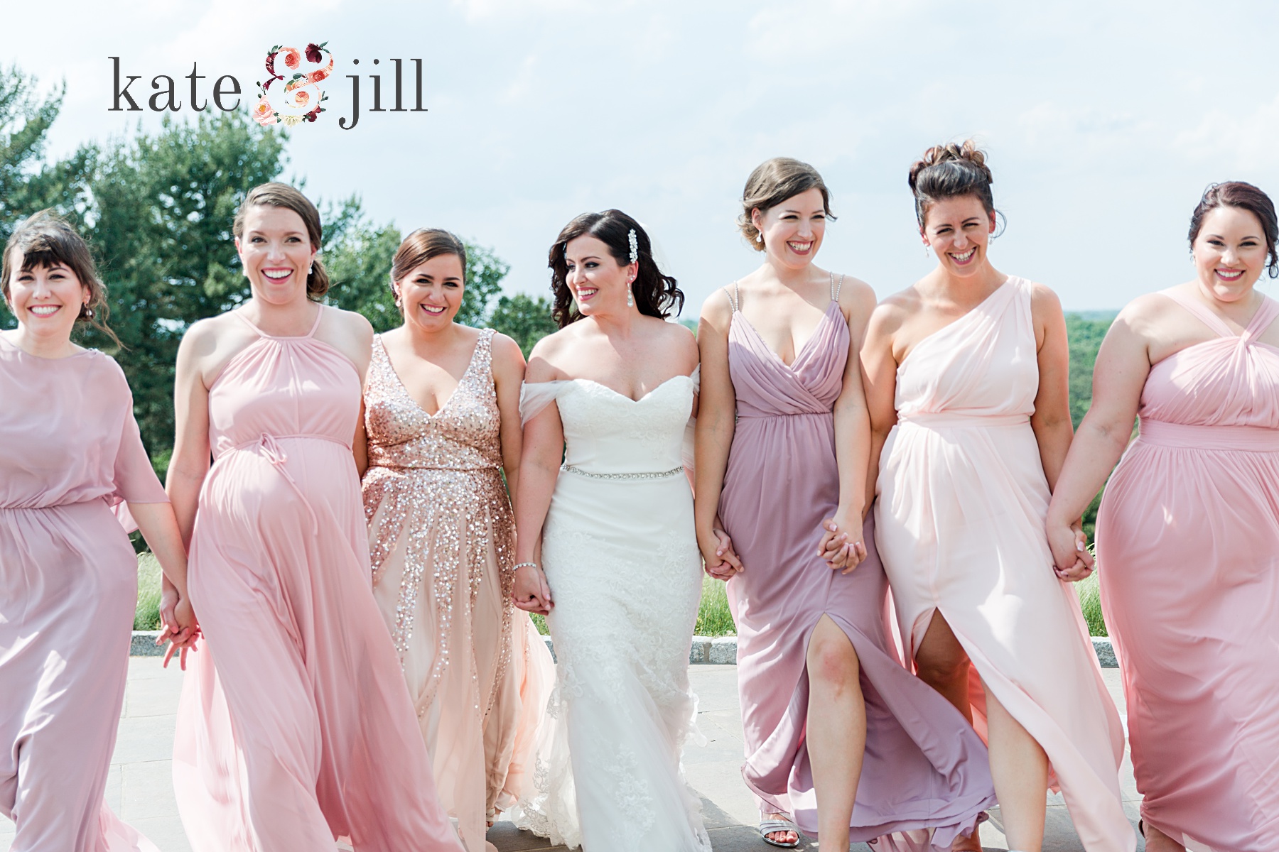 bridesmaids in pink dresses walking