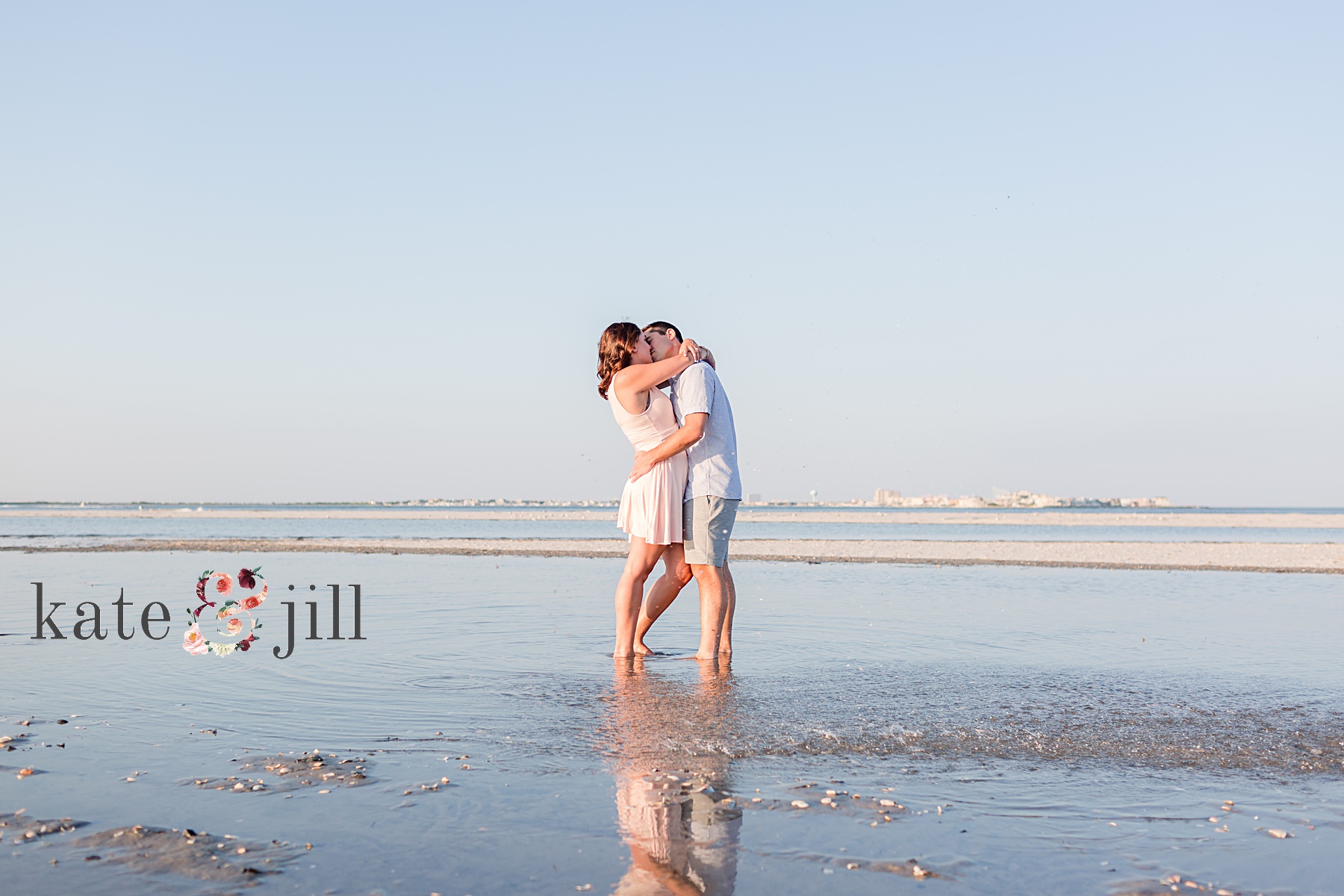 couple standing in water kissing