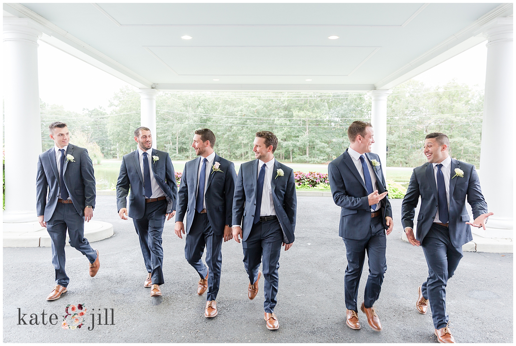 groom walking with groomsmen 