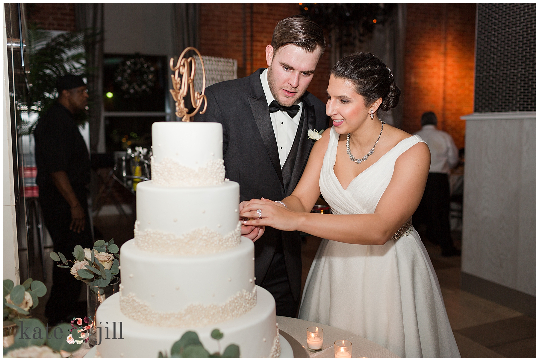 bride and groom cutting cake 