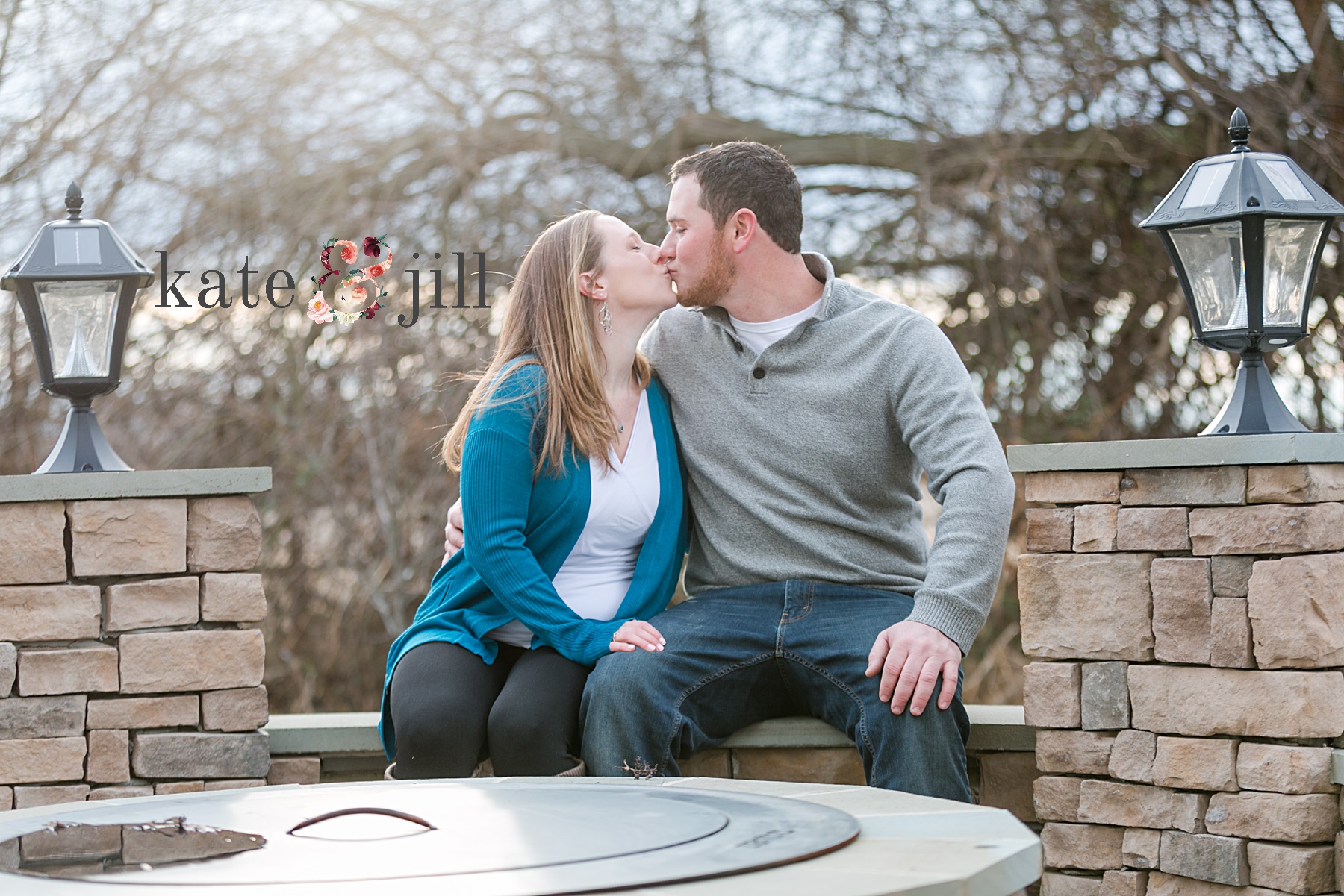 couple kissing by fire pit