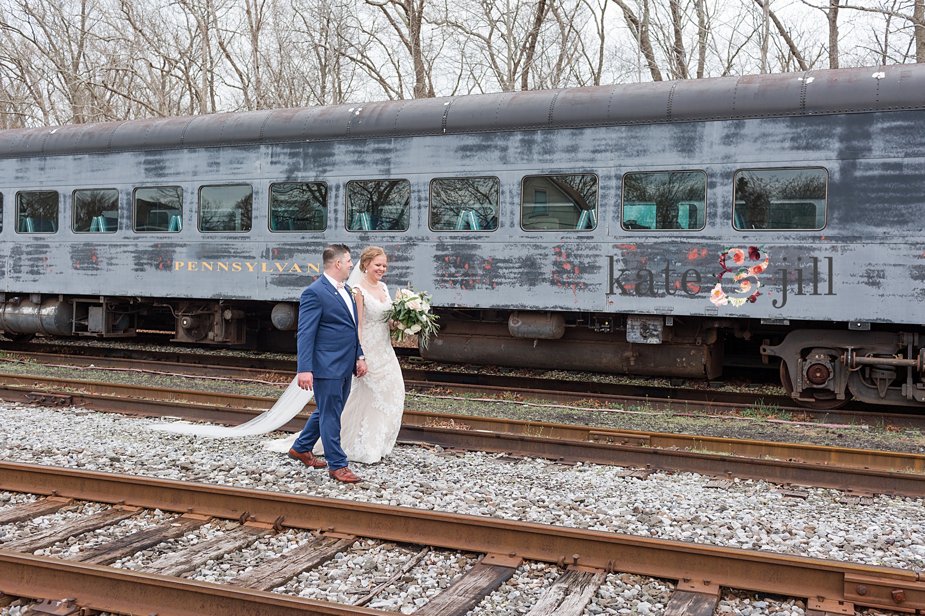 bride and groom walking railroad wedding photos