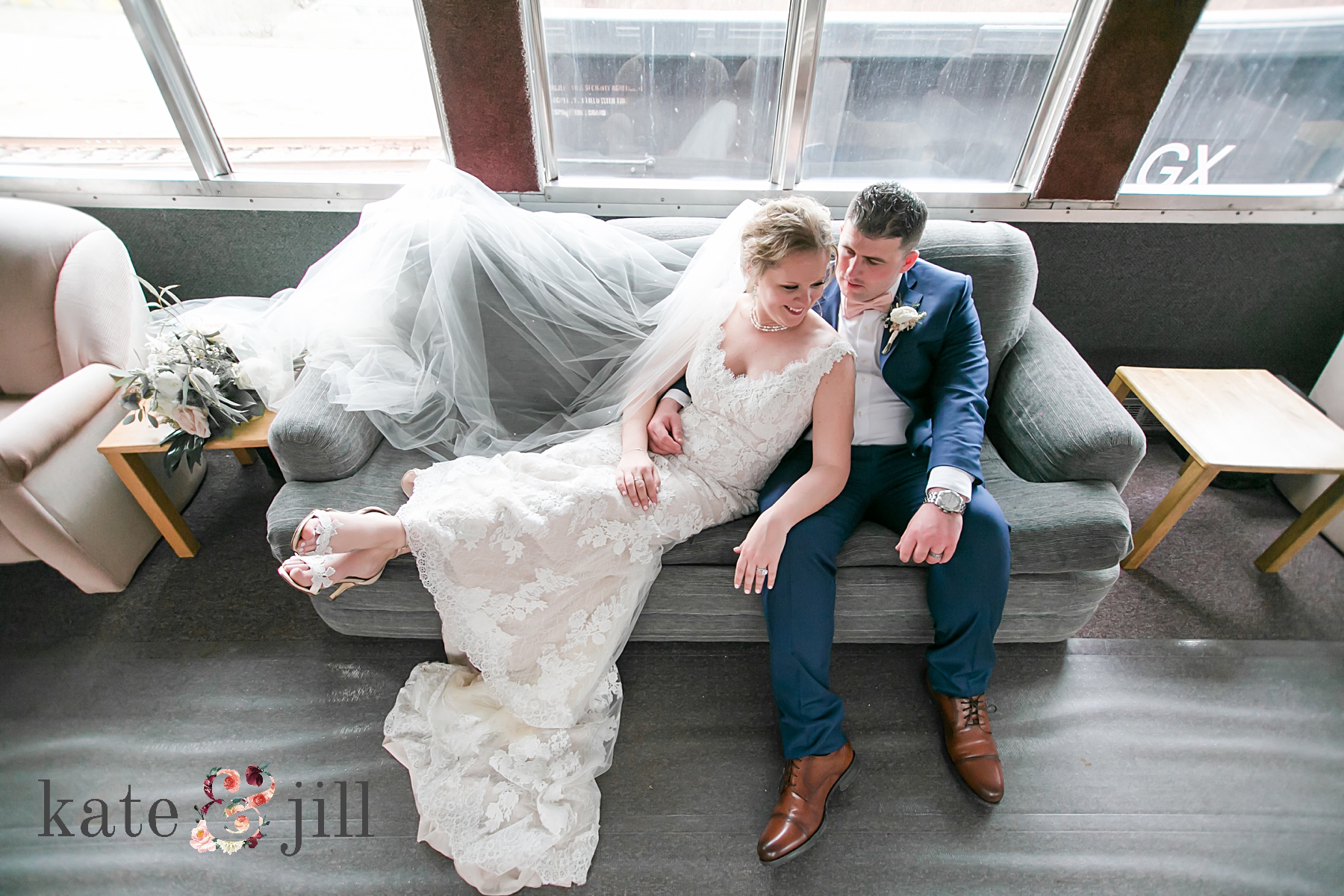 bride and groom sitting in train car