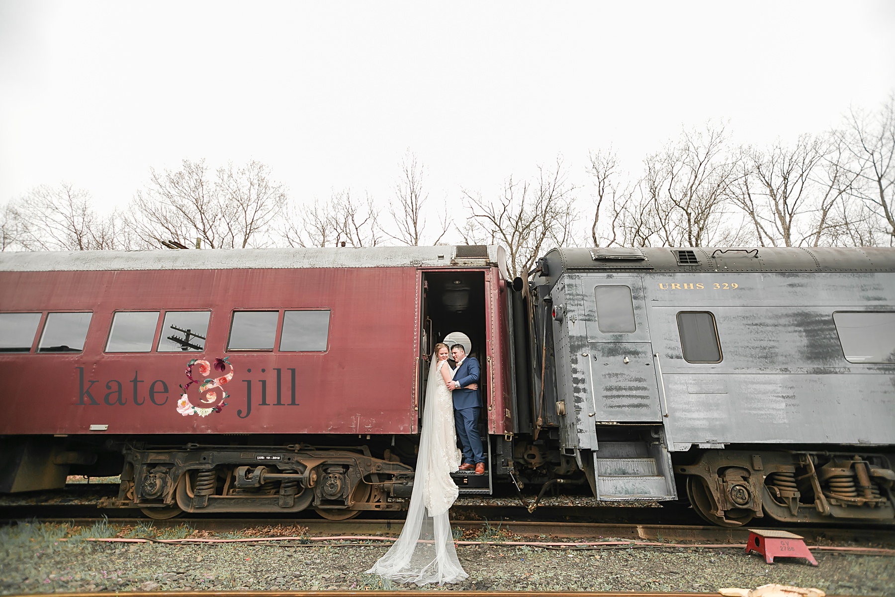 bride and groom hanging off train car