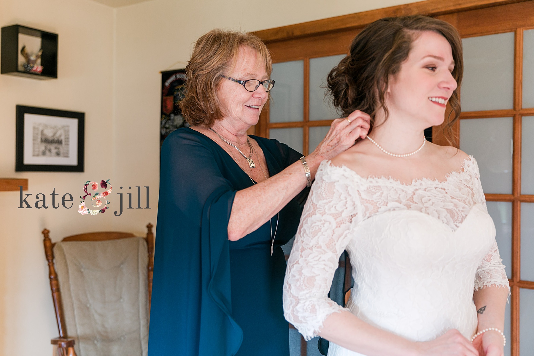 mom putting on brides necklace