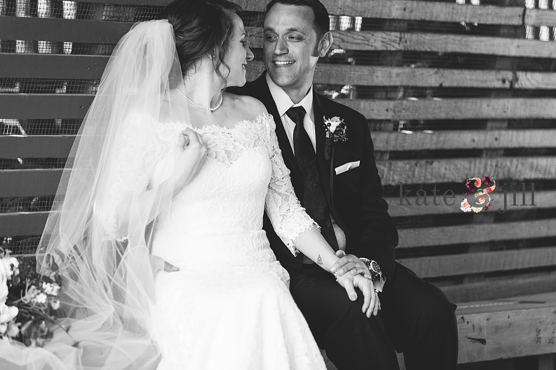 black and white bride sitting together on bench