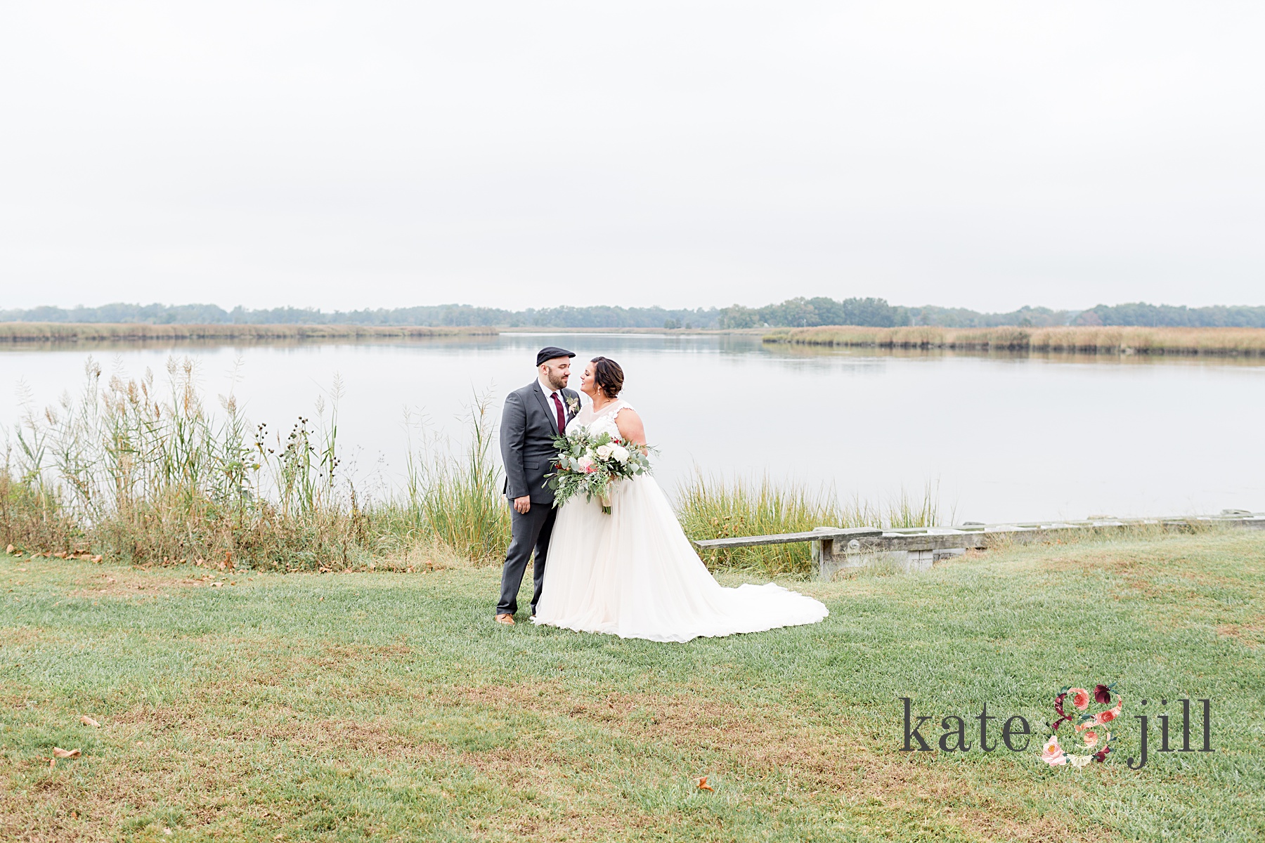 bride and groom in front of water