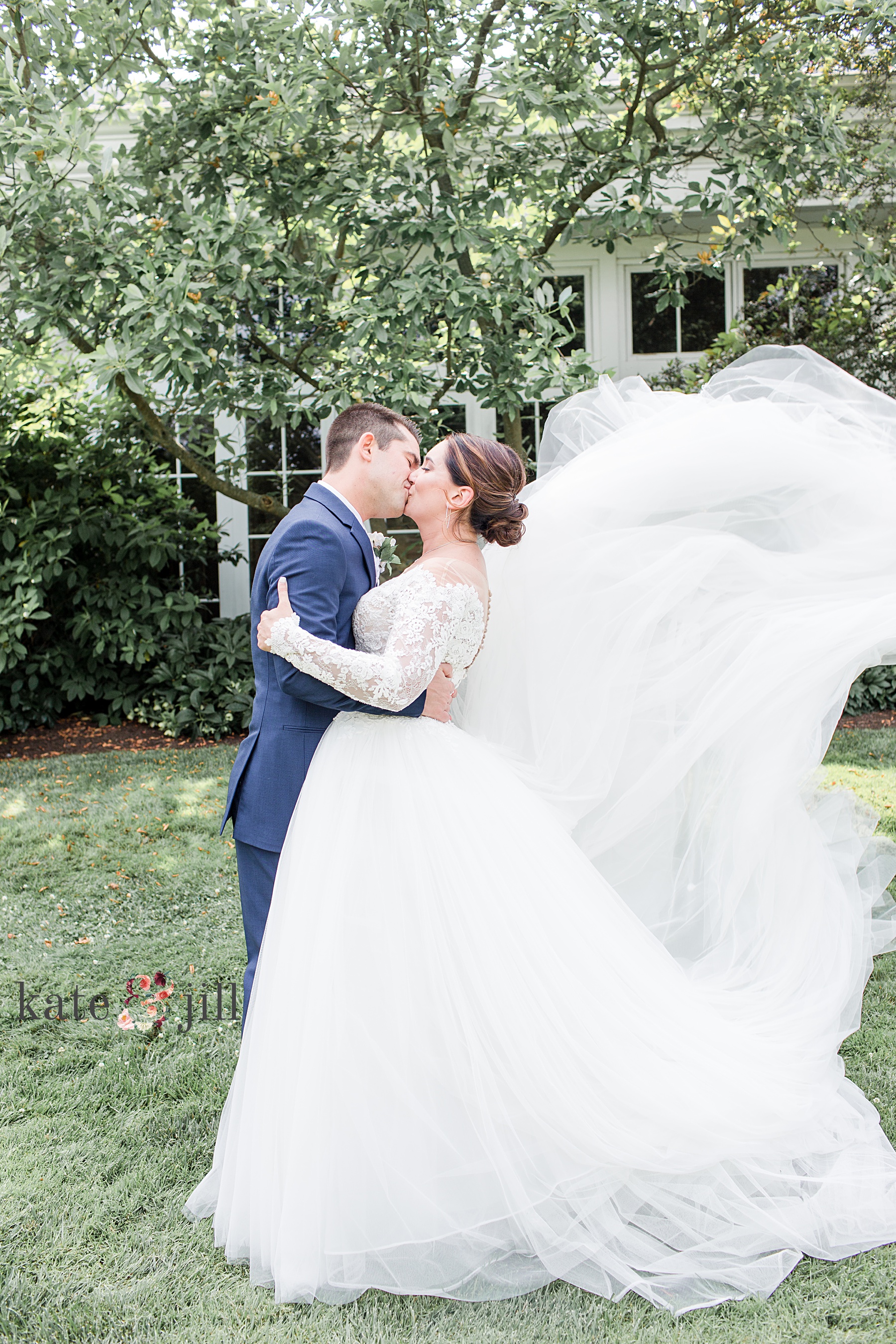 bride and groom kissing dress flying