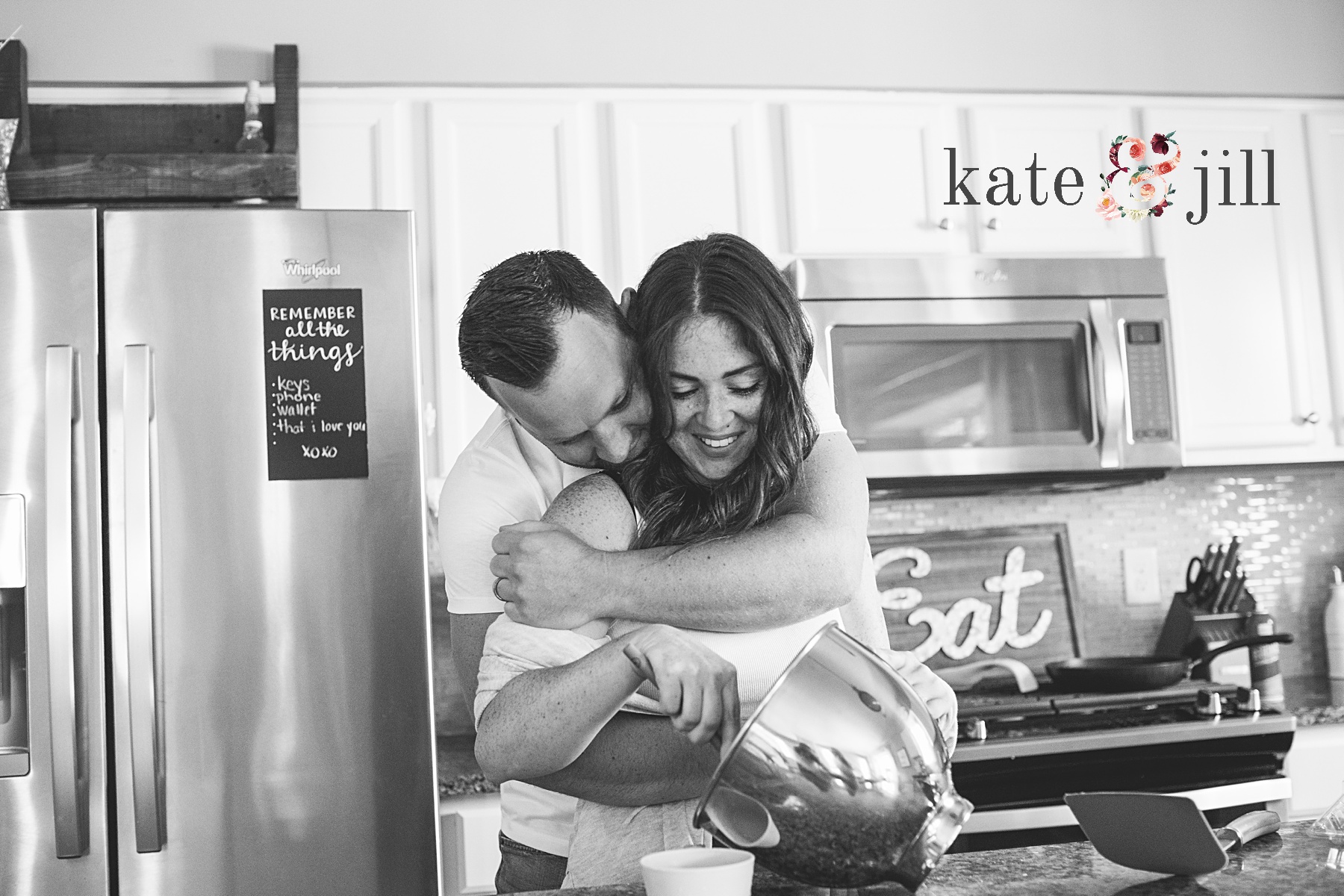 couple snuggling in kitchen