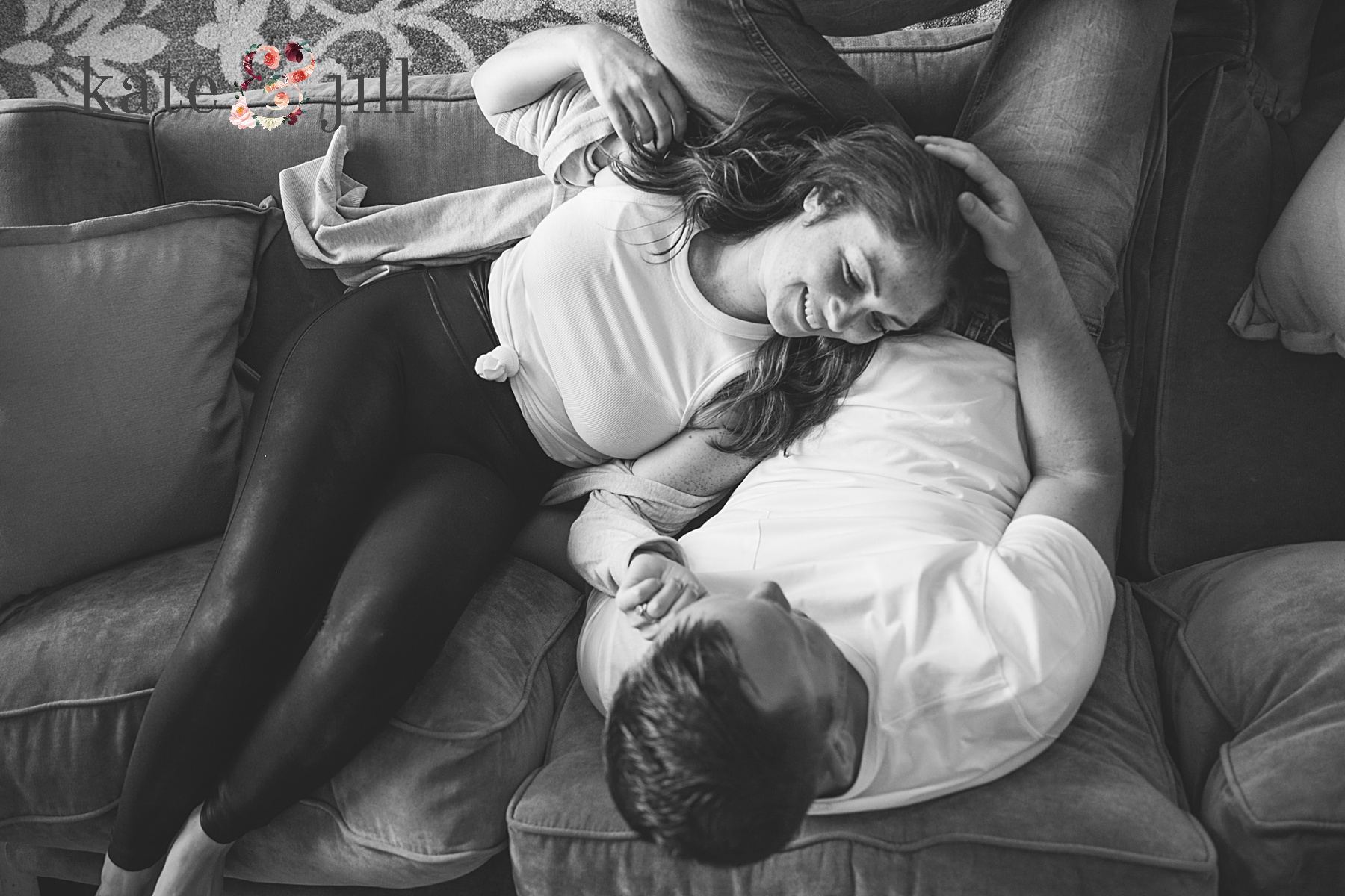 couple snuggling on sofa in home session