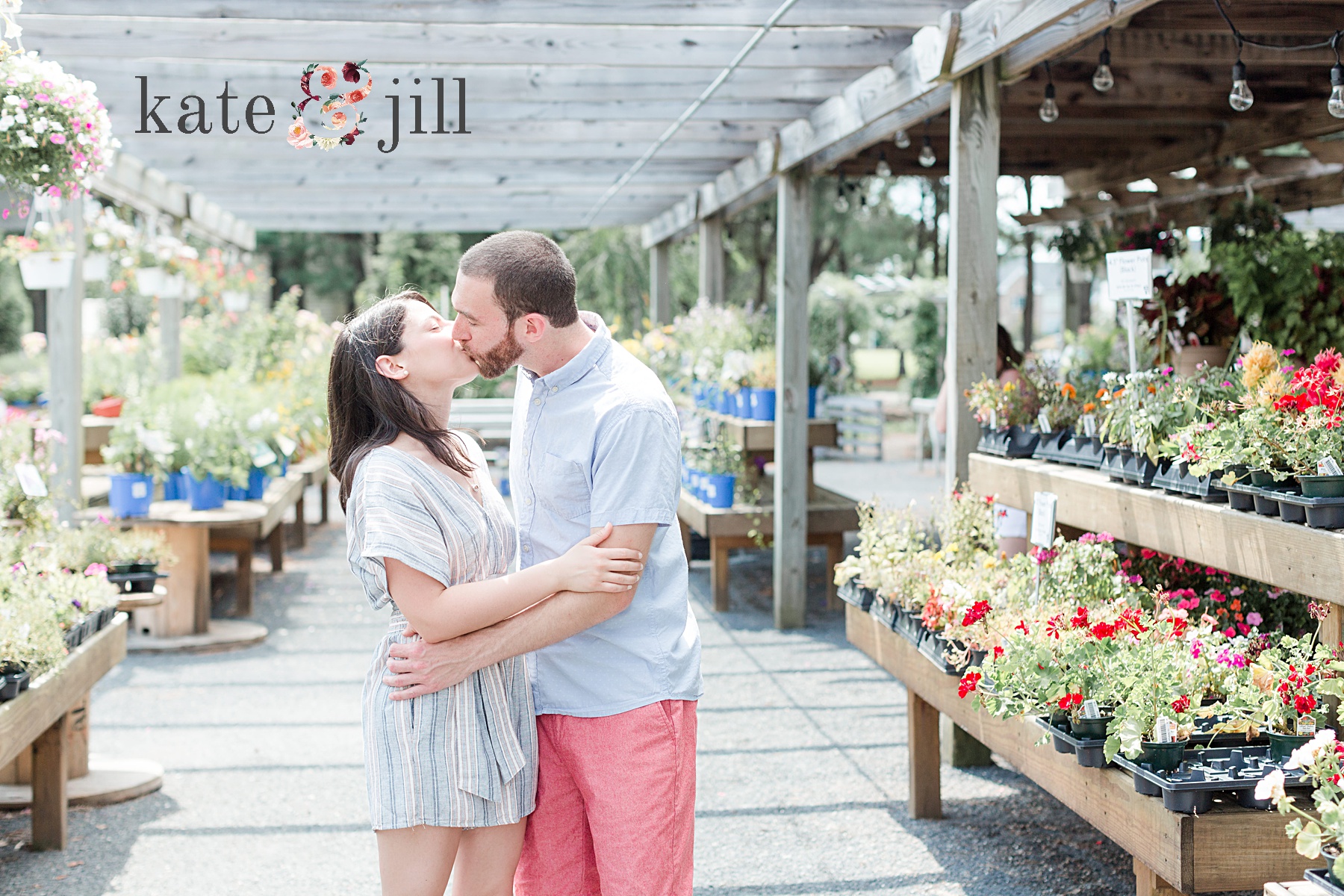 couple kissing garden center engagement session