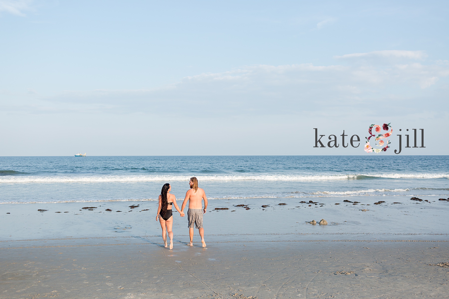 couple in bathing suits running to water