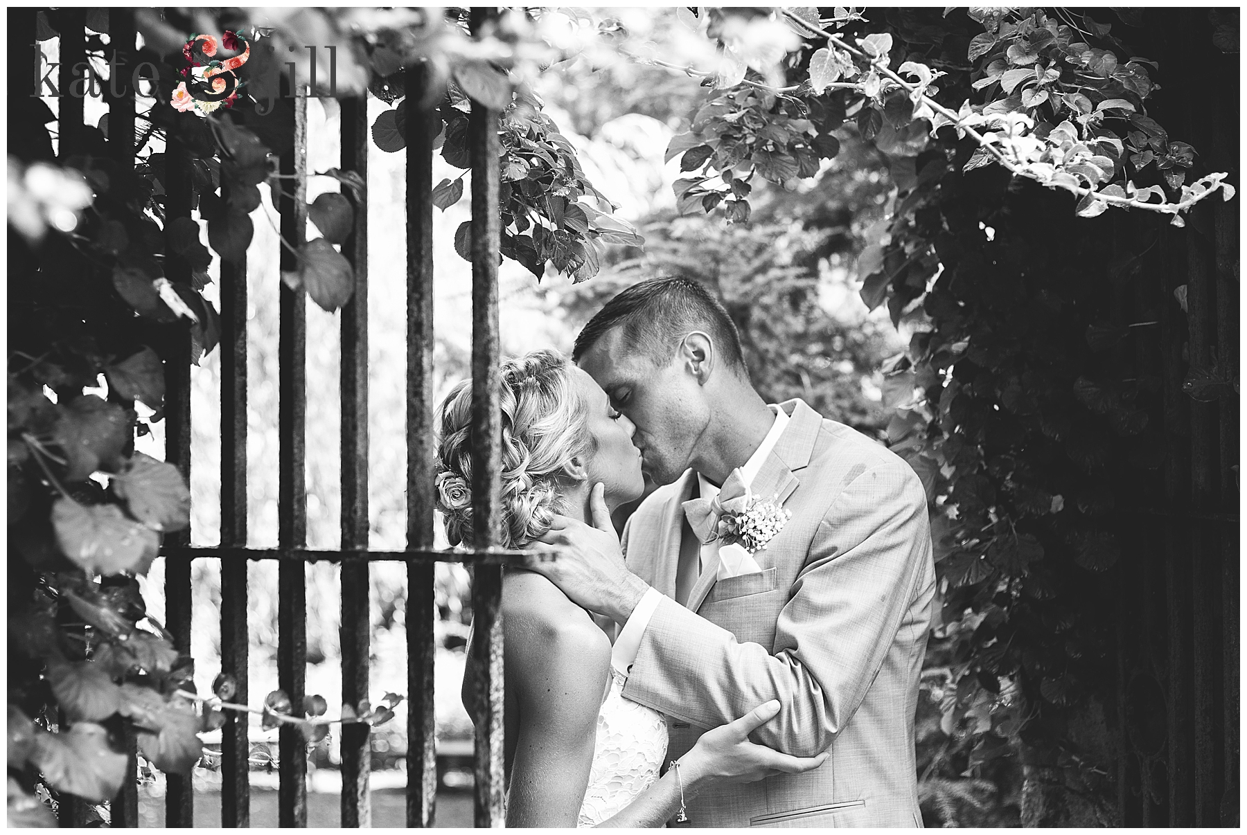 bride and groom kissing at gate