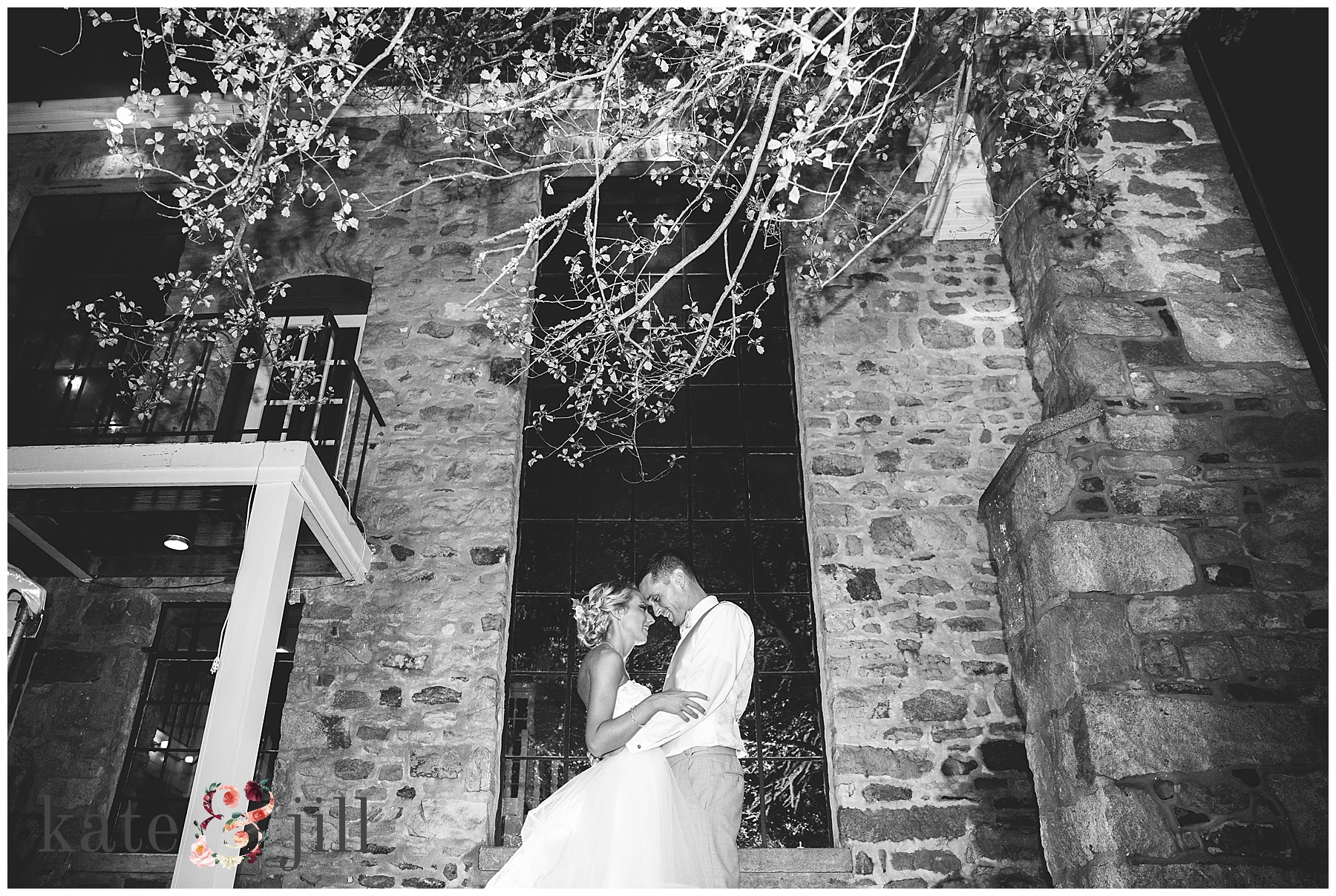night photo of bride and groom outside venue