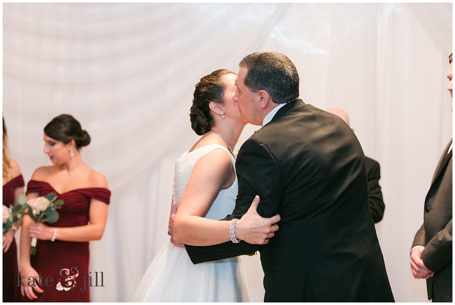 bride kissing father on cheek