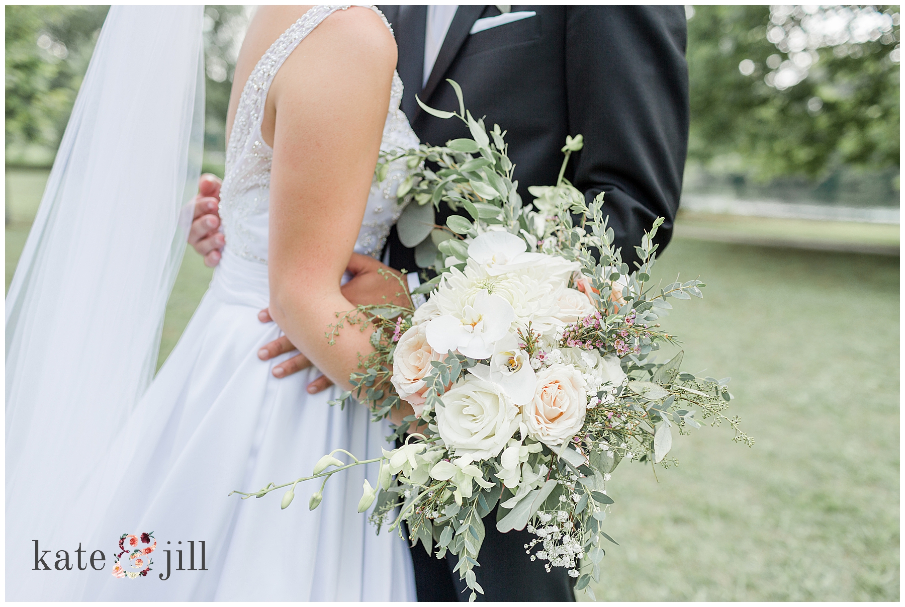 bride and groom holding wedding bouquet 