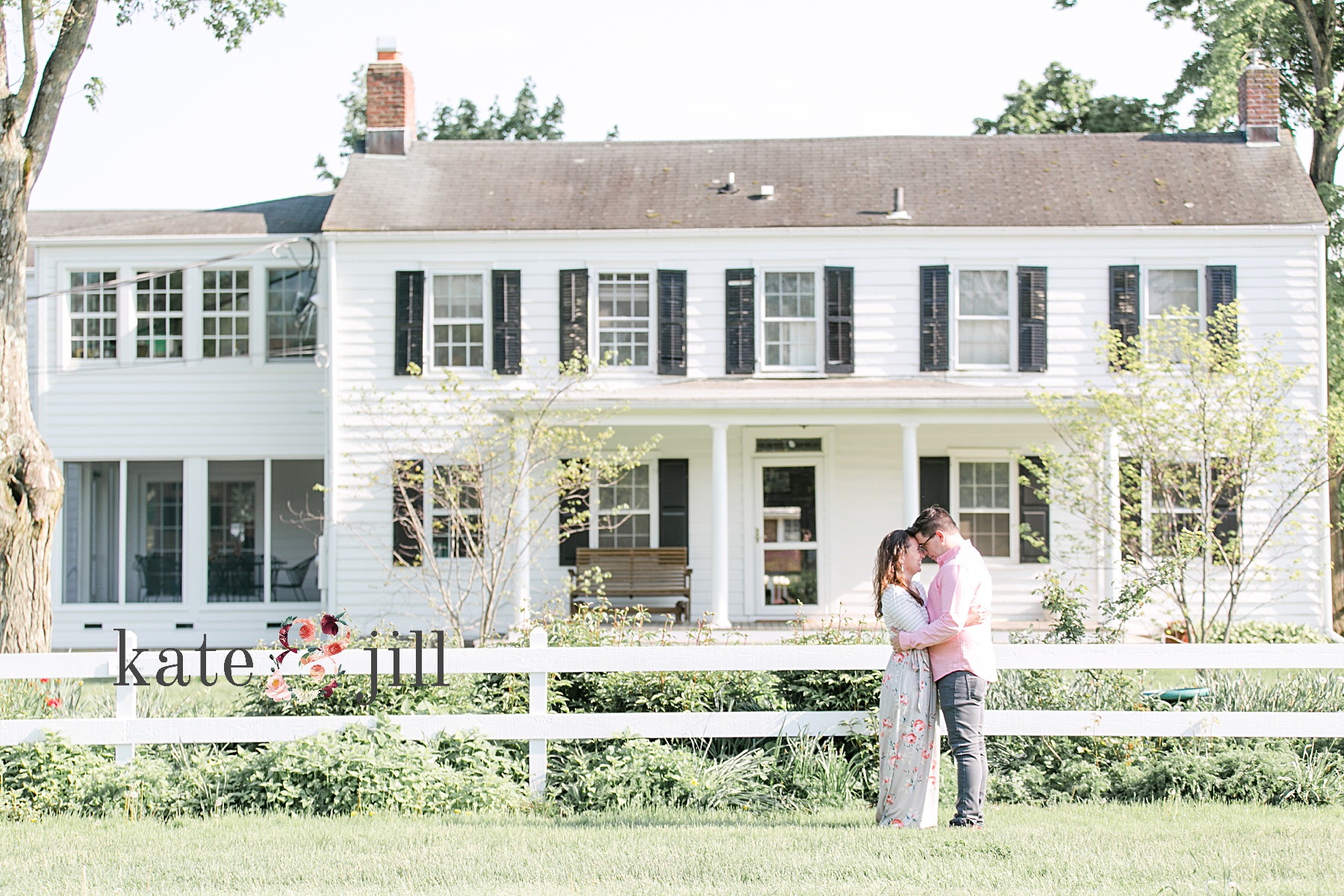 couple in front of farmhouse