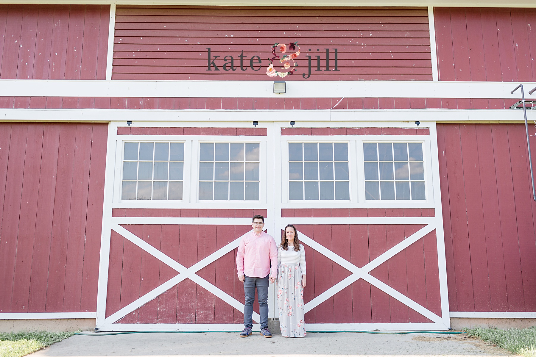 couple standing in front of a barn side by side terhune orchards engagement photos