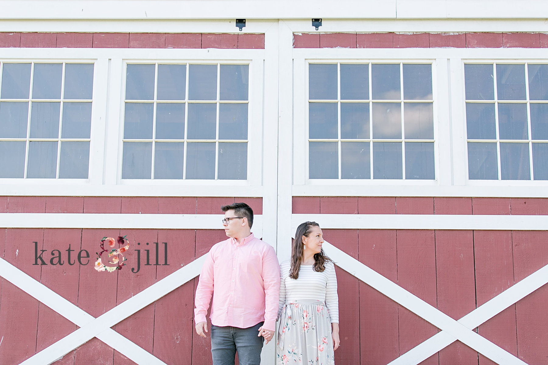 couple standing in front of a barn side by side
